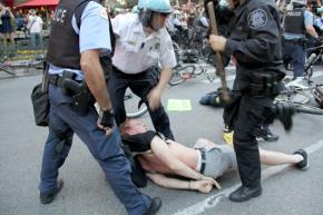 Police arrest a protester in Chicago during a mass anti-NATO march